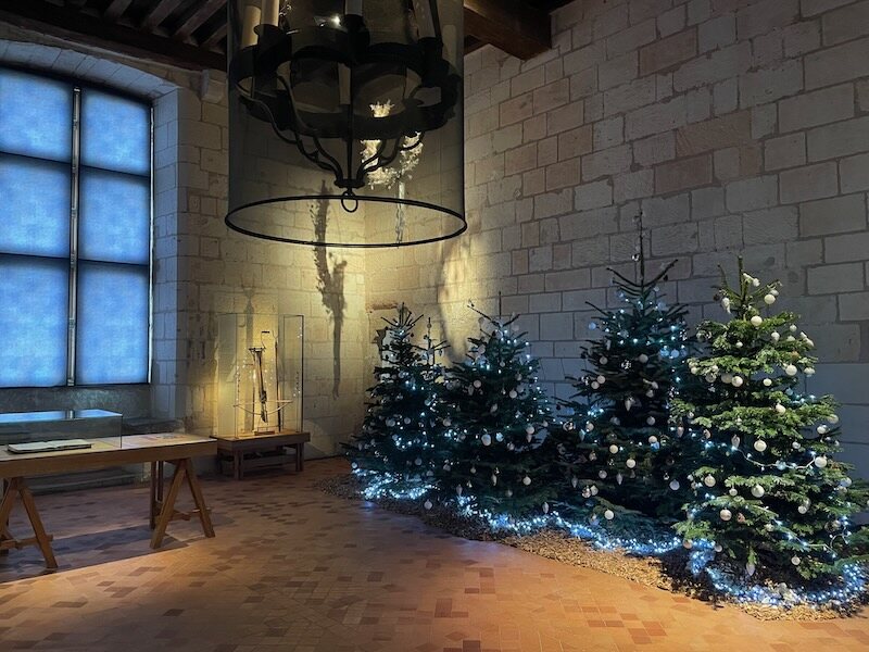 Christmas trees in a cavernous medieval room of Loches castle