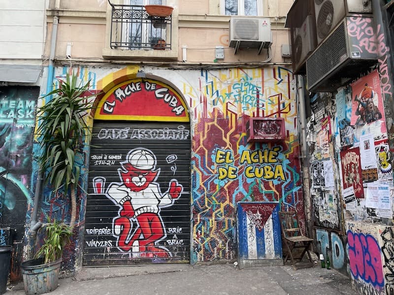 Shuttered storefront with graffiti in the Cours Julien area of Marseille.