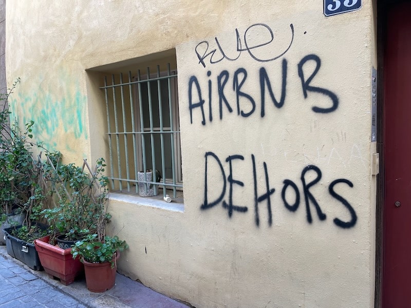 Anti-airbnb graffiti on a wall in Le Panier district of Marseille.