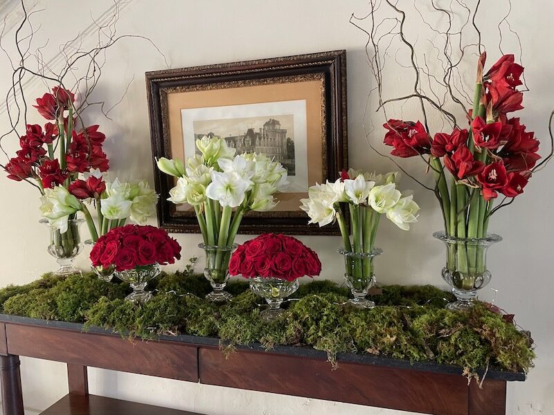 Red and white flowers over grass on a mantlepiece at Villandry Castle over Christmas